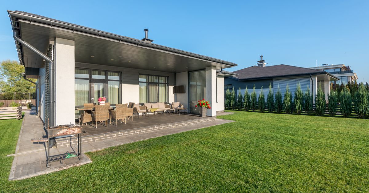 A residential home with a well-maintained yard and landscaped garden