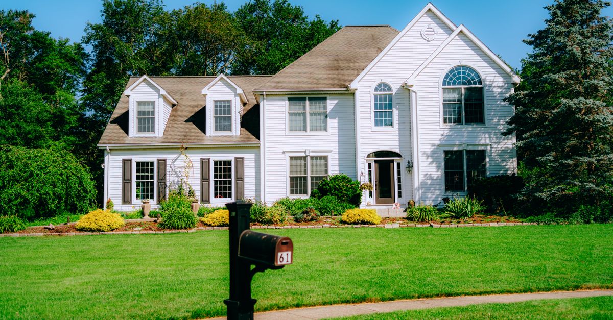 Healthy suburban home with a well-maintained green lawn